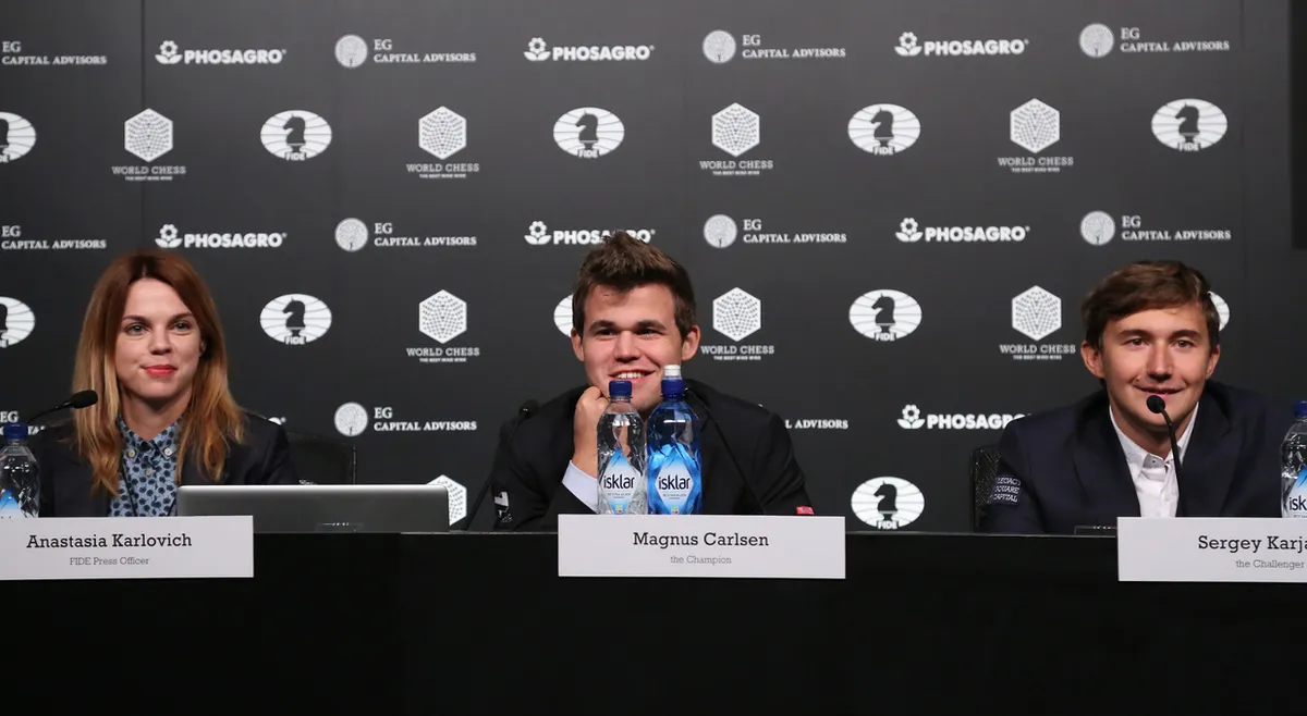 NEW YORK, NY - NOVEMBER 11: (L-R) FIDE Press Officer Anastasia Karlovich, Reigning Chess Champion Magnus Carlsen and Chess grandmaster Sergey Karjakin speak at a press conference after a game during 2016 World Chess Championship at Fulton Market Building on November 11, 2016 in New York City. (Photo by Rob Kim/Getty Images for Agon Limited )